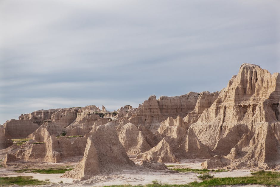 Explore the dramatic rock formations in the Badlands under a clear sky, showcasing nature's artistry.