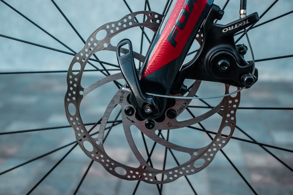 Detailed view of bicycle's disc brake rotor and caliper, showcasing intricate gear design.