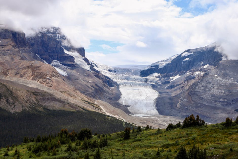 A breathtaking landscape of Athabasca Glacier in Jasper National Park, surrounded by mountains.