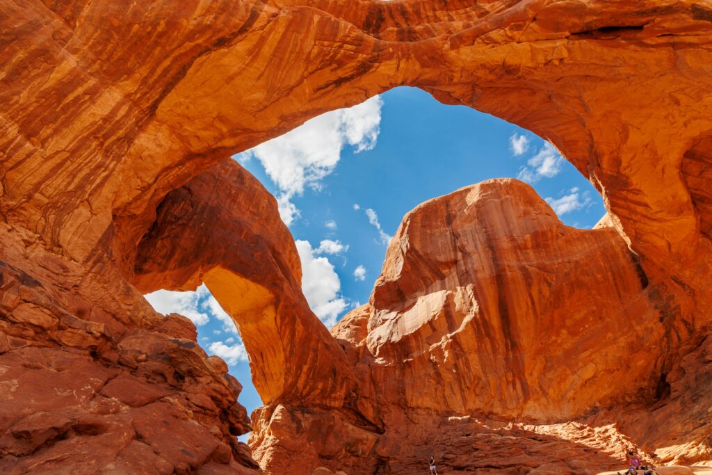 Spectacular view of a natural arch with rugged red rock formations in Arches National Park, Utah.