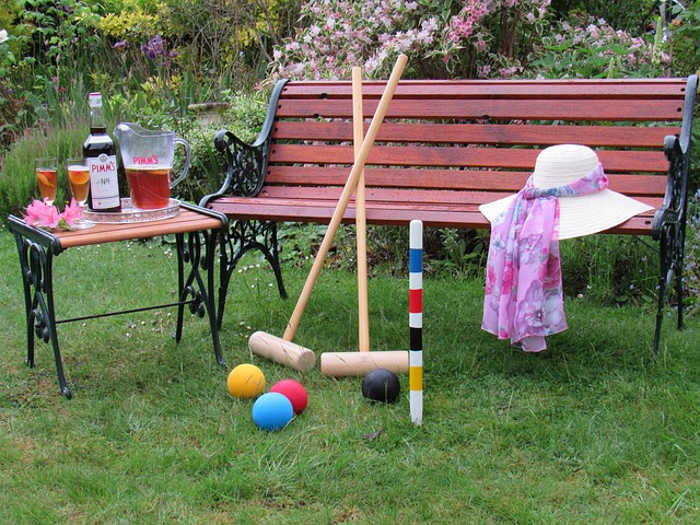 Vintage-style croquet set arranged on a green backyard lawn, ready for a casual spring game day.