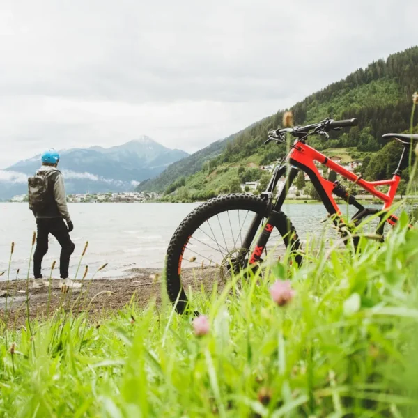 Cyclist overlooking Zell am See in Salzburg, Austria. Perfect for adventure and travel themes.