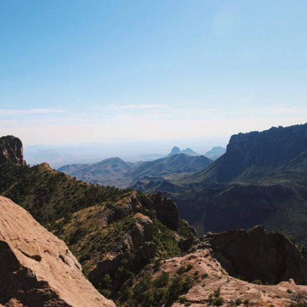 Capture the breathtaking views of Big Bend National Park's rugged mountain terrain under a clear blue sky.