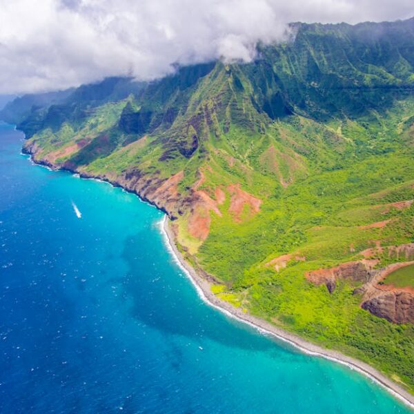 A captivating view of Hawaii's Na Pali Coast with vibrant blue ocean and lush mountains.